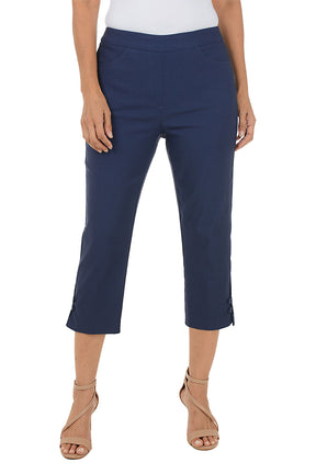 Navy blue capri pants worn by a person on a white background.