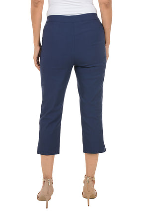 Navy blue capri pants worn by a person on a white background. Back shot.