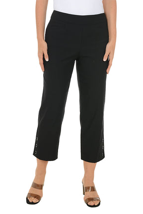 Black crop pants worn by a person on a white background.