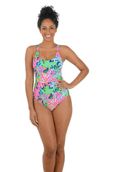 Woman wearing a colorful one-piece swimsuit on a white background.