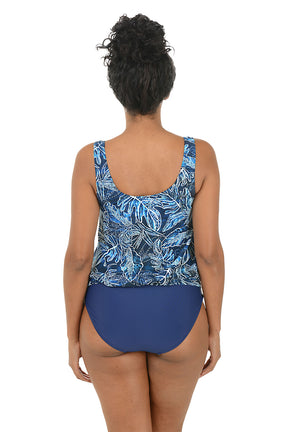 Woman wearing a blue leaf-patterned swimsuit on a white background. Back shot.