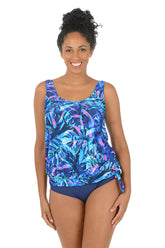 Woman wearing a colorful tankini top with a white background.