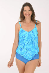 Woman wearing a blue floral tankini set on a white background.