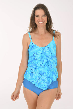 Woman wearing a blue floral tankini set on a white background.