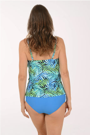 A woman wearing a blue and green tropical leaf print tankini swim top. Back shot.