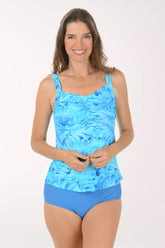 Woman wearing a blue floral tankini set on a white background.