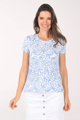 Woman wearing a blue floral patterned shirt on a white background