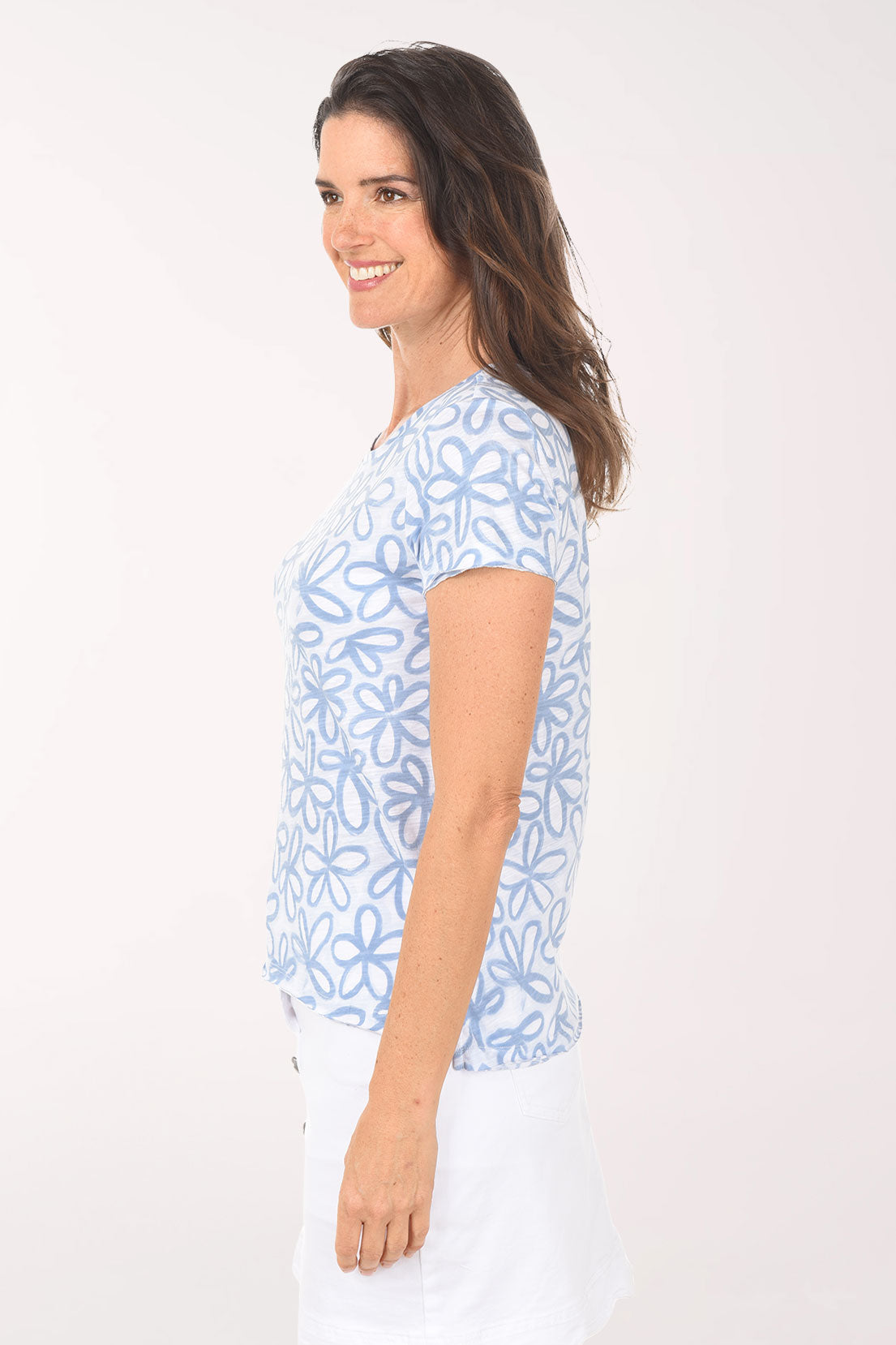 Woman wearing a blue floral patterned shirt on a white background
