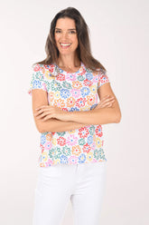 Woman wearing a colorful floral-patterned top on a white background