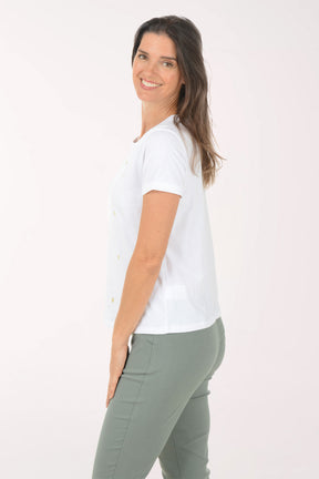 Woman wearing a white t-shirt and green pants on a white background