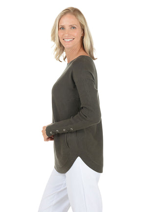 Woman wearing a green sweater with button details on a white background. Side shot.
