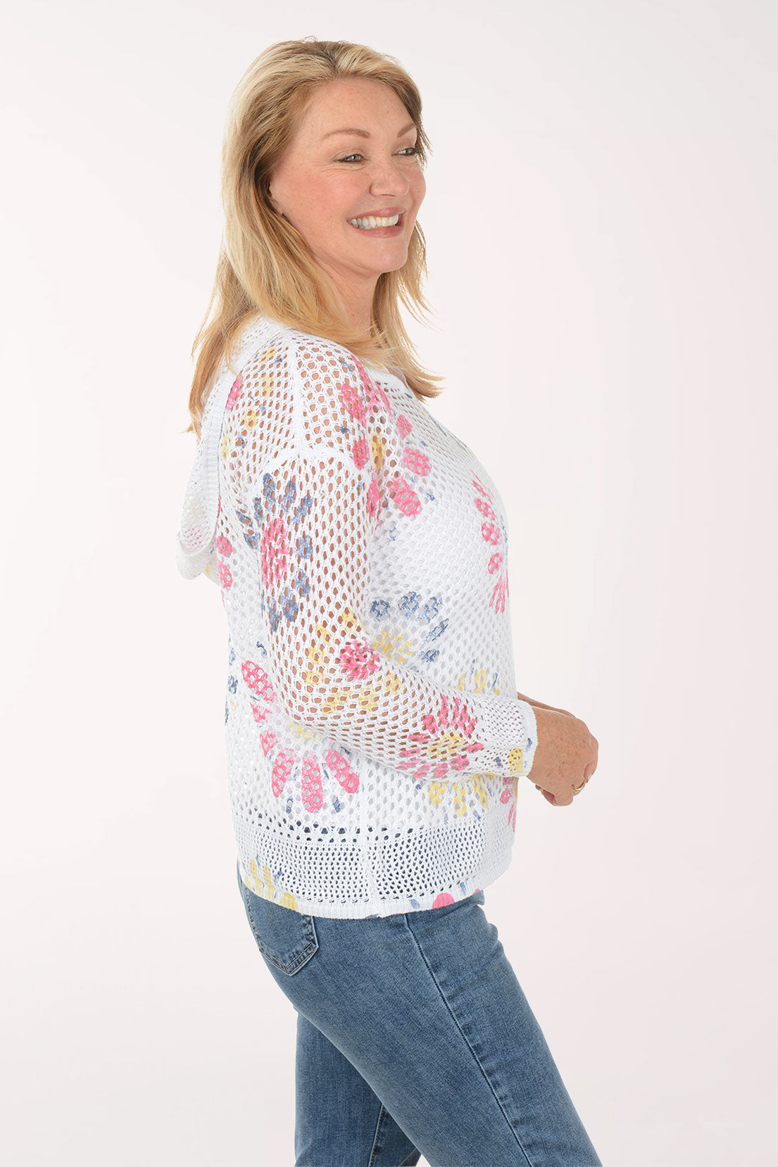 Woman wearing a white floral-patterned sweater on a white background