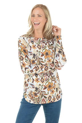 Woman wearing a floral long-sleeve top on a white background.