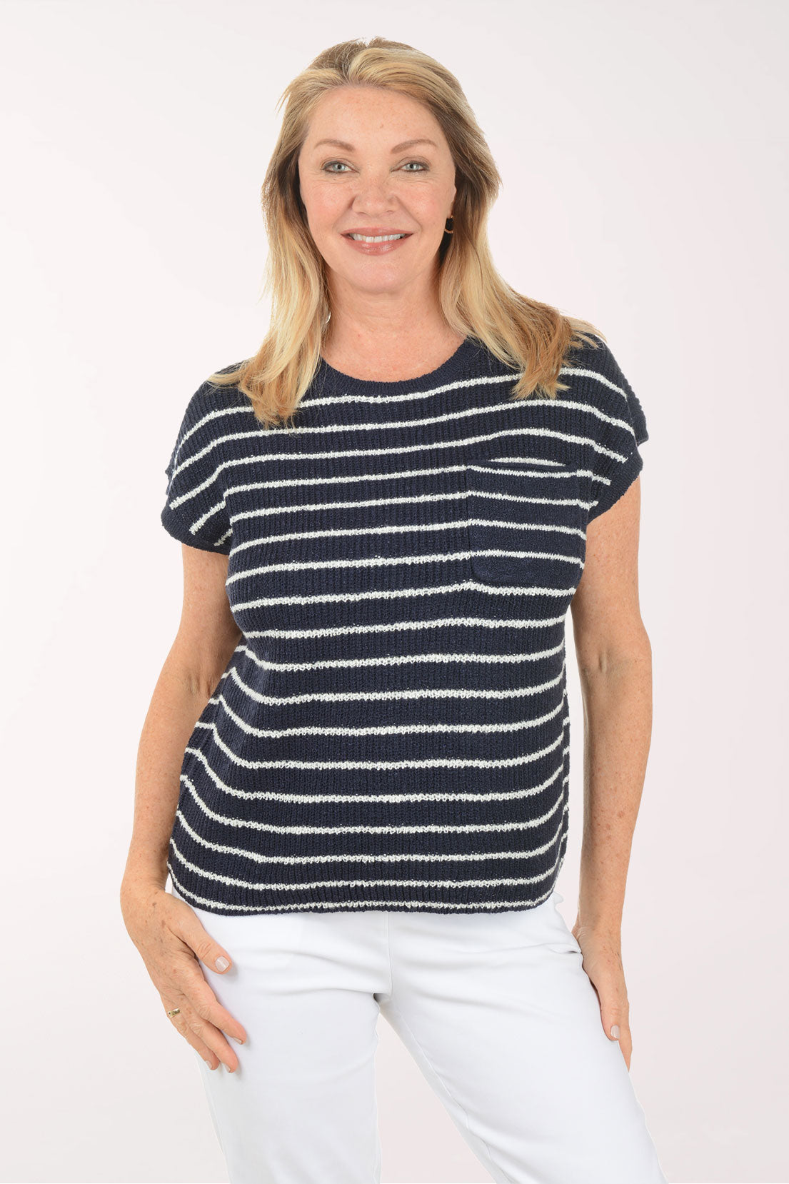 Woman wearing a navy and white striped shirt on a white background