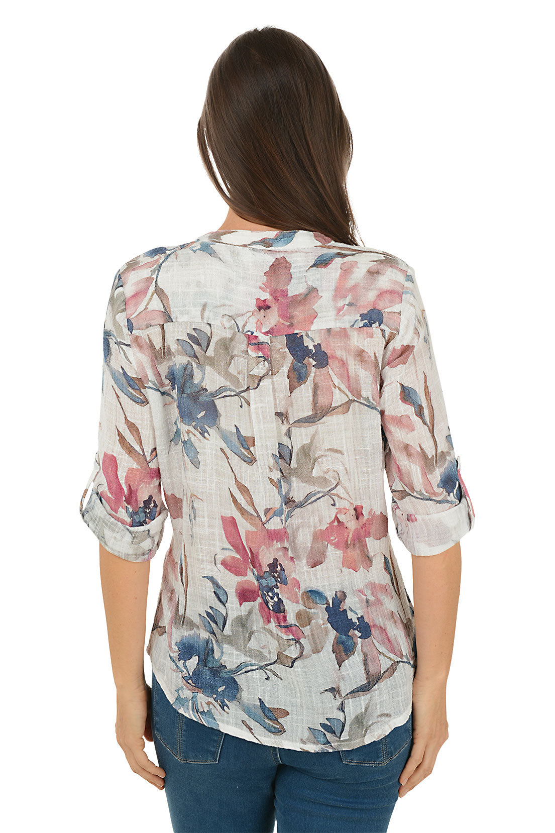 Woman wearing a floral blouse with blue jeans on a white background