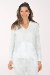 Woman wearing a light blue striped shirt and pants on a white background