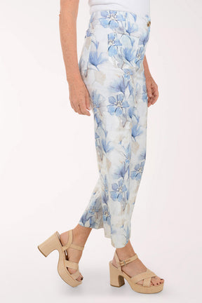 Floral-patterned pants worn by a person on a white background