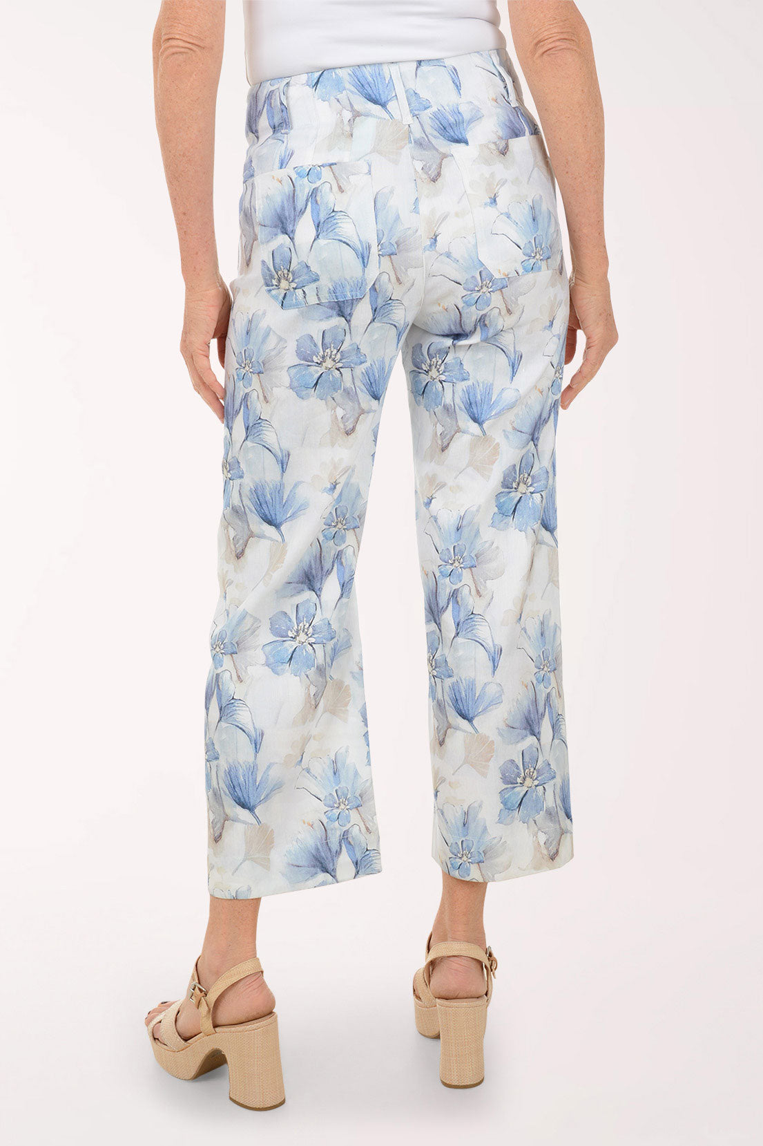Floral-patterned pants worn by a person on a white background