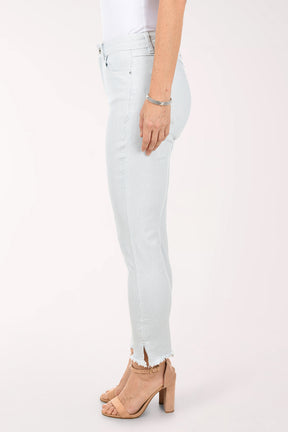 Person wearing light blue jeans with a white background
