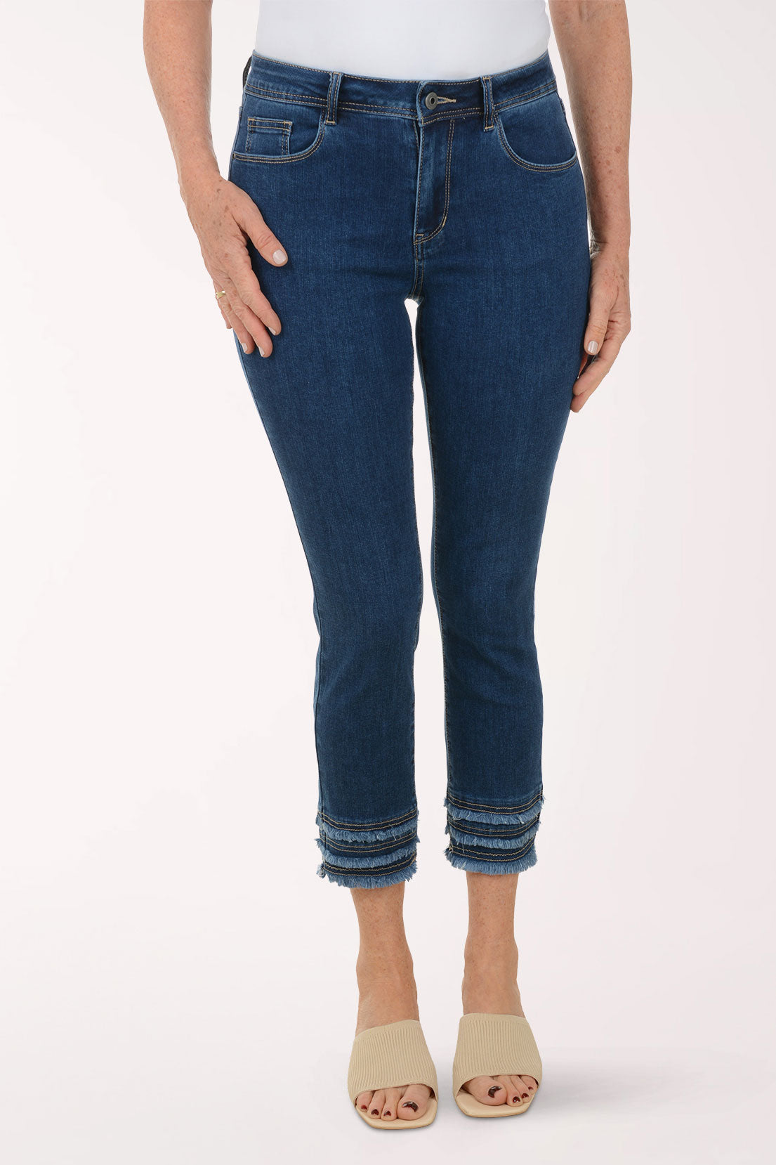 Person wearing blue jeans on a white background