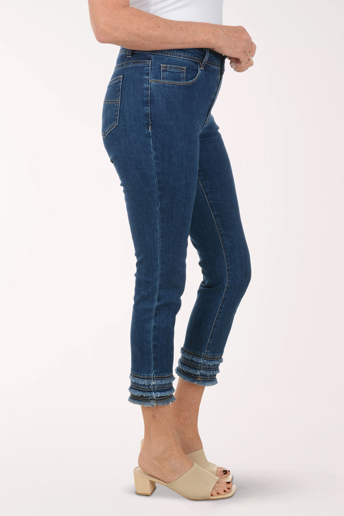 Person wearing blue jeans on a white background