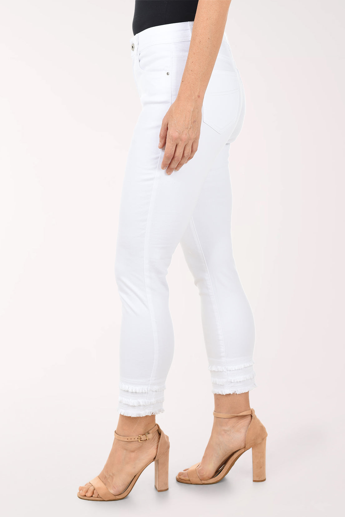 White jeans worn by a person on a white background