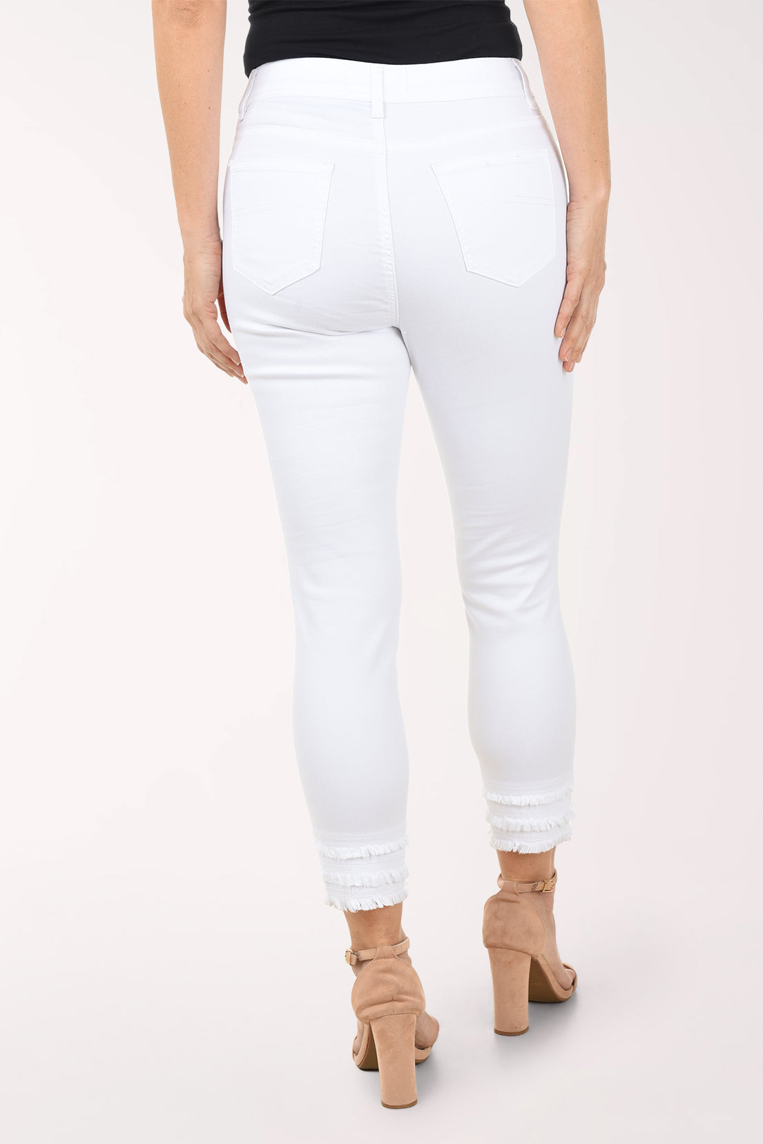 White jeans worn by a person on a white background