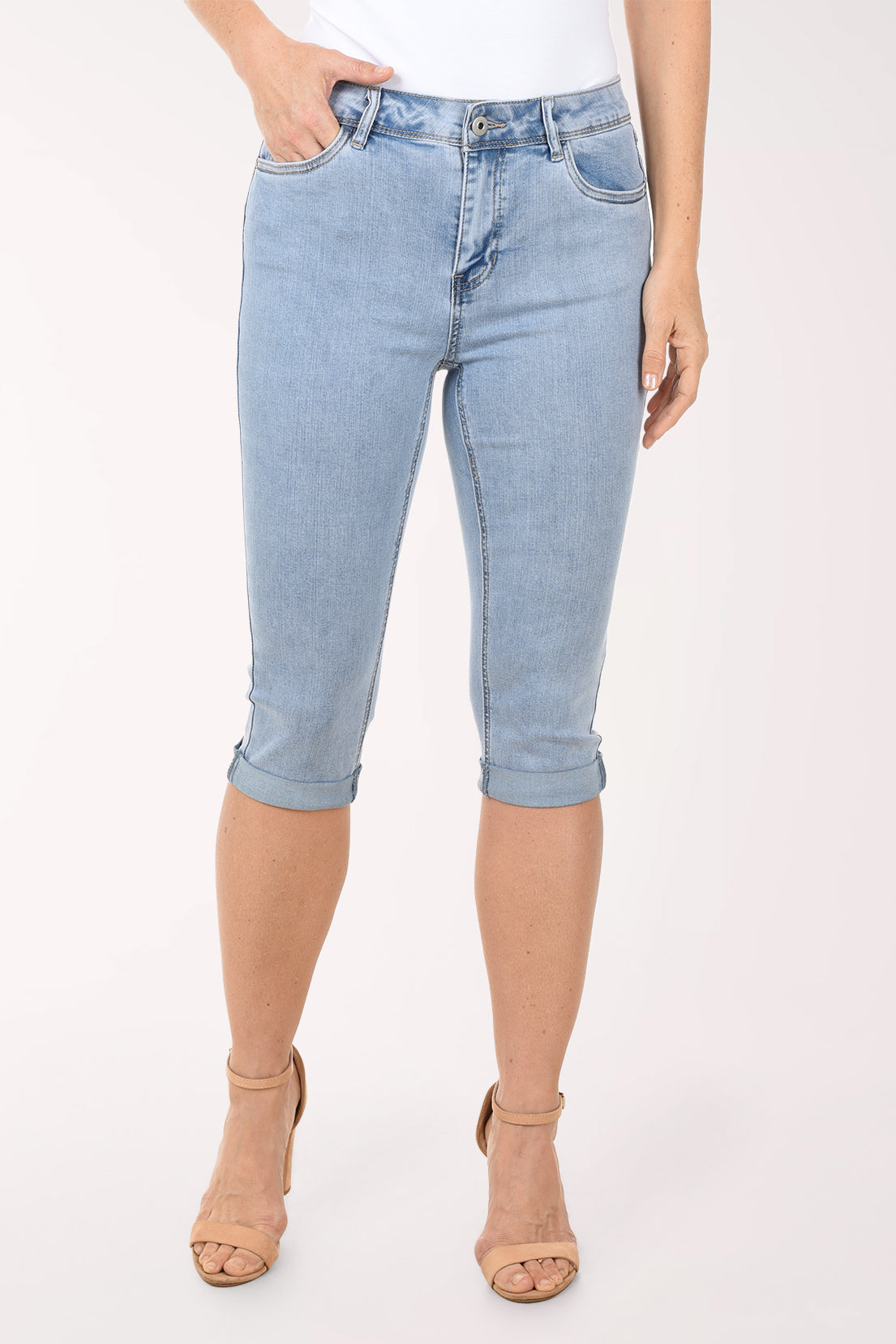 Light blue denim capri jeans worn by a person on a white background