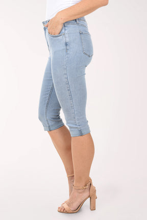 Light blue denim capri jeans worn by a person on a white background