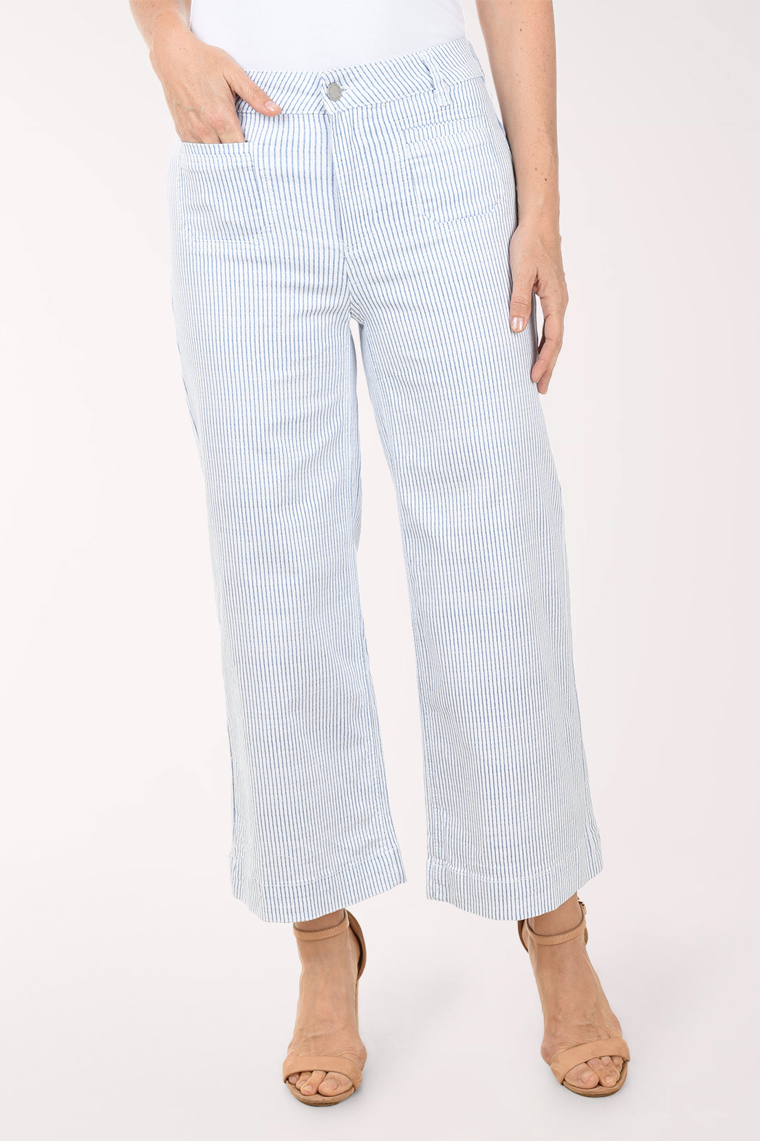 Light blue and white striped pants worn by a person on a white background