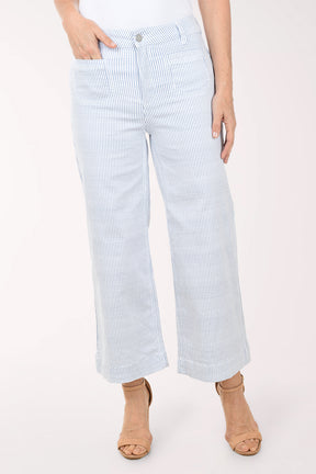 Light blue and white striped pants worn by a person on a white background