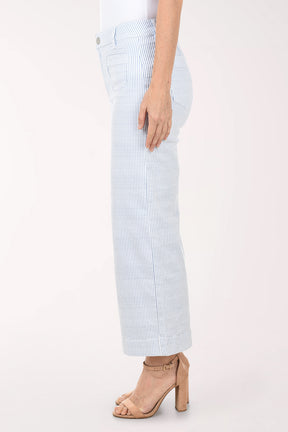 Light blue and white striped pants worn by a person on a white background