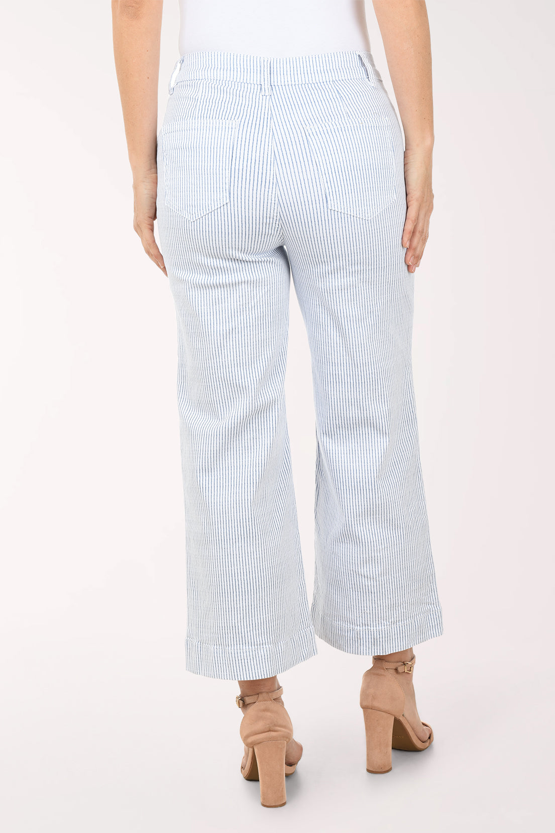 Light blue and white striped pants worn by a person on a white background