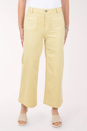 Person wearing light yellow pants on a white background