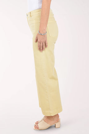 Person wearing light yellow pants on a white background
