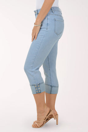 Light blue jeans with rolled-up cuffs worn by a person on a white background