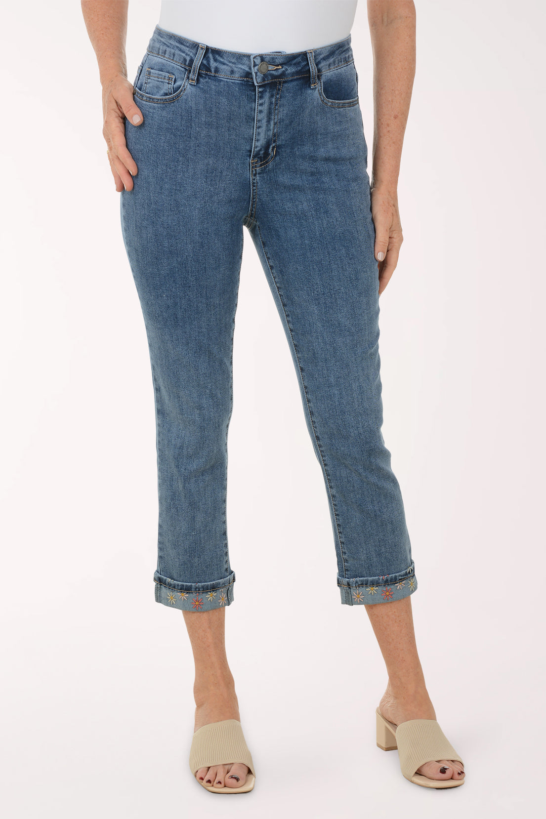 Person wearing blue jeans on a white background