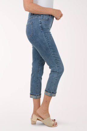 Person wearing blue jeans on a white background