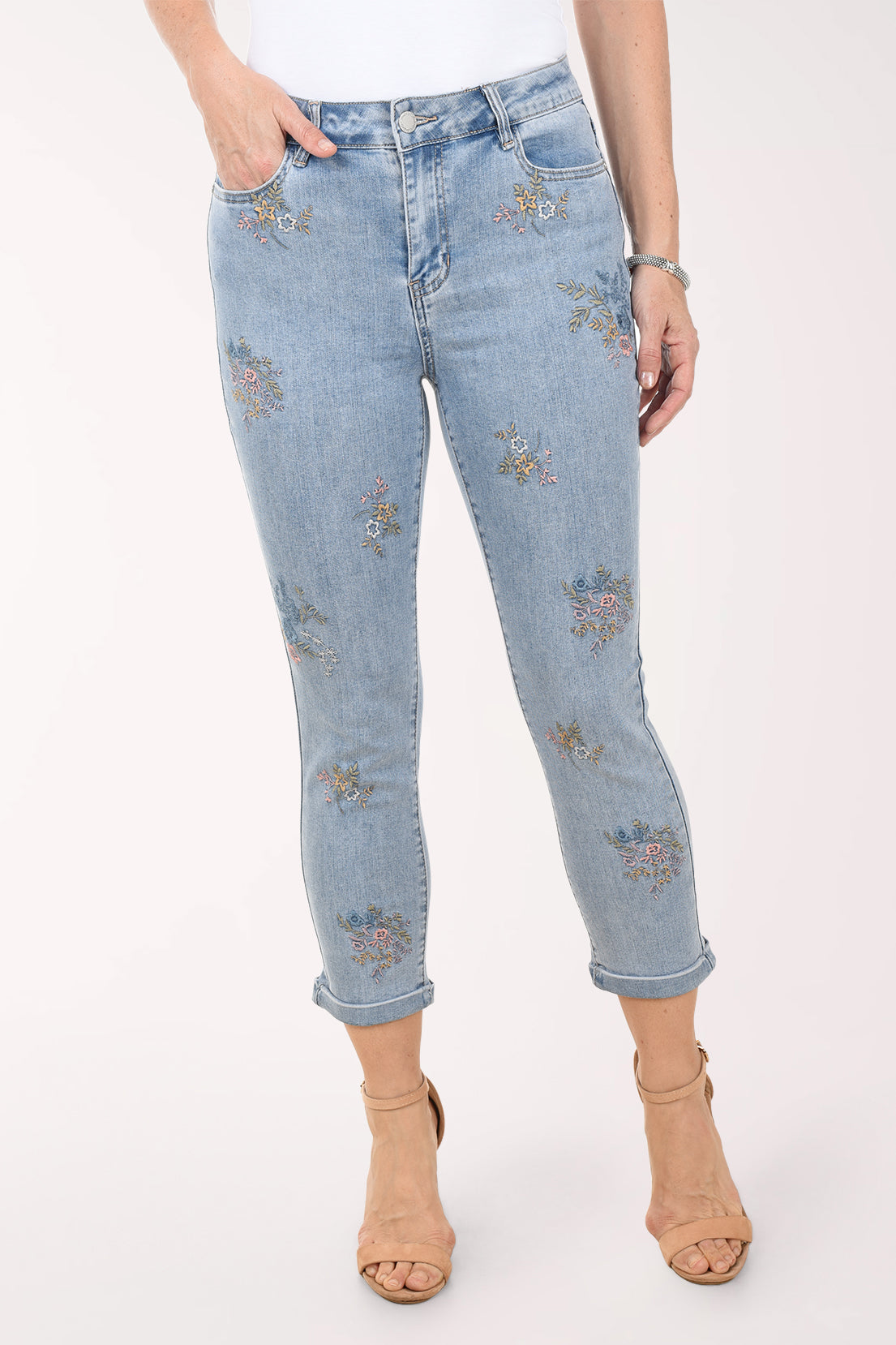 Light blue jeans with floral embroidery on a white background