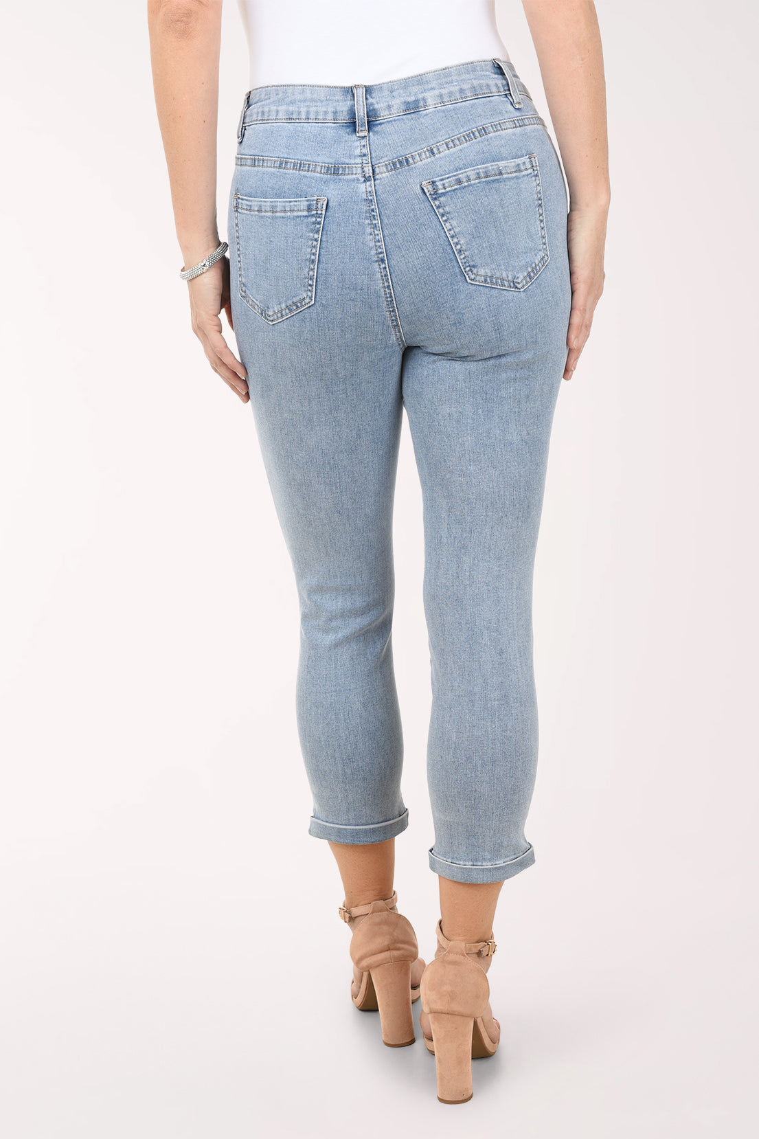 Light blue jeans with floral embroidery on a white background