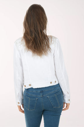 Woman wearing a white denim jacket with gold buttons on a white background
