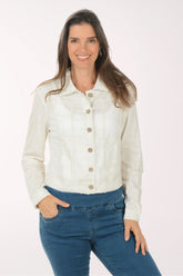 Woman wearing a white denim jacket and blue jeans on a white background