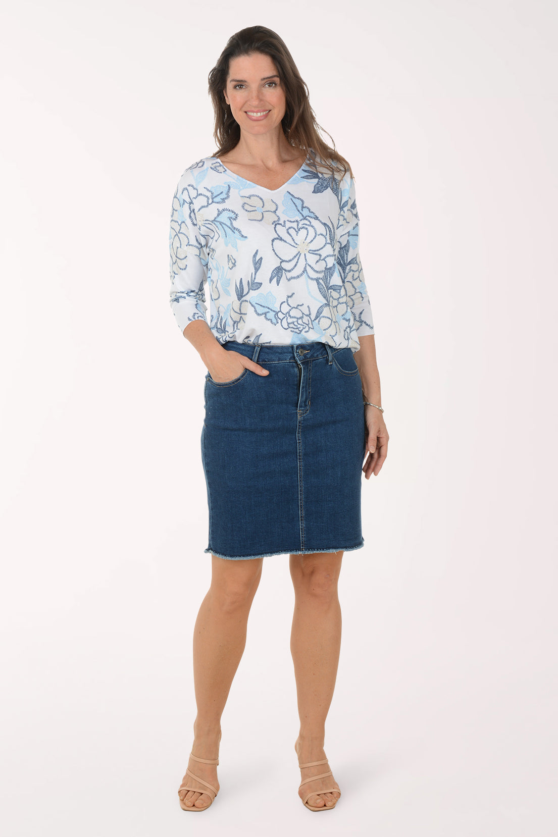 Woman wearing a blue denim skirt.