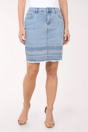 Light blue denim skirt worn by a person on a white background