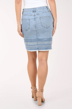 Light blue denim skirt worn by a person on a white background