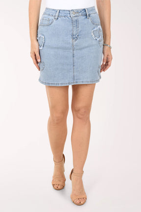 Light blue denim skirt worn by a person on a white background