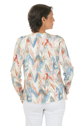 Woman wearing a colorful zigzag patterned sweater on a white background. Back shot.