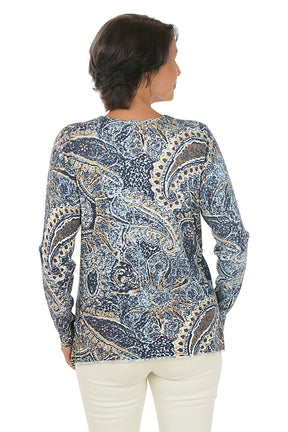 Woman wearing a blue paisley patterned sweater on a white background. Back shot.