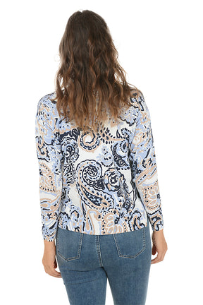 Woman wearing a blue paisley patterned sweater and jeans on a white background. Back shot.
