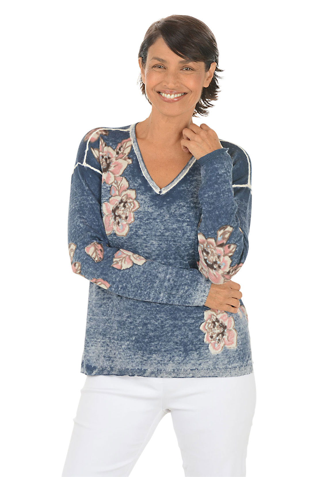 Woman wearing a blue floral-patterned sweater on a white background.
